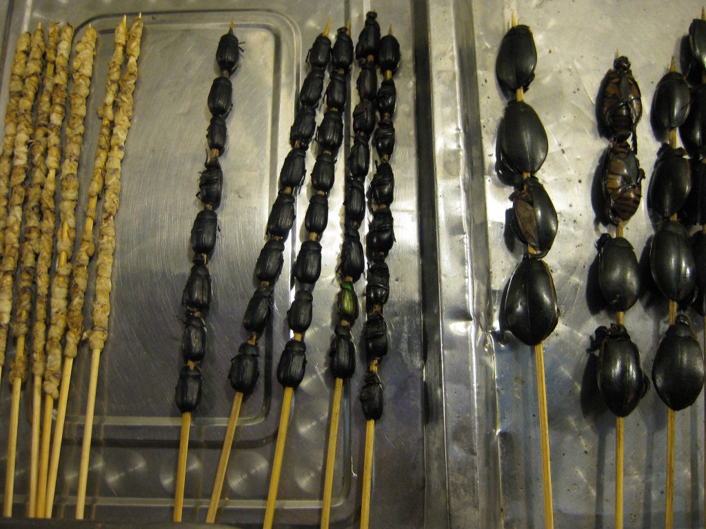 Honeybee, beetle, and cockroach skewers for sale ... for dinner. 